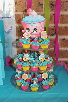 cupcakes and cakes are displayed on a table