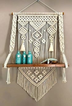 a macrame wall hanging on a shelf