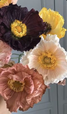 an arrangement of different colored flowers in a vase