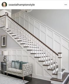 a living room filled with furniture and a stair case