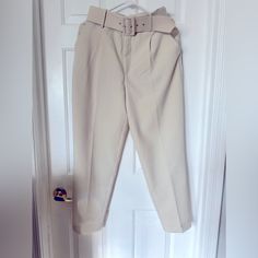 Elevate Your Wardrobe With These Stylish High-Waisted Pants From Zara. Perfect For Any Occasion, These Pants Feature A Solid Pattern And A Cream Color That Complements Any Outfit. The Pants Are Made Of Polyester Material And Have A Pleated Front Type, A Classic Fit, And A Straight Leg Style. The Pants Come With A Fabric-Covered Belt That Adds An Extra Touch Of Elegance To The Outfit. The Belted Feature Is Perfect For Travel, Party/Cocktail, Casual, And Business Occasions. These Pants Are Availab High Waist Pants For Office In Summer, High Waist Office Pants For Summer, Belted Bottoms For Office In Spring, Belted Bottoms For Business Casual Summer, Belted Bottoms For Spring Office Wear, Spring Office Wear: Belted Bottoms, Spring Office High-waist Bottoms, Spring Office High Waist Bottoms, Trendy Pants With Belt Loops For Day Out