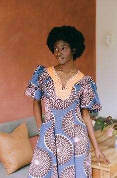 Named after, and drawing inspiration from Annie's West-African grandmother Monica, this dress is infused with the vibrant energy and joyful essence that Ghana is globally celebrated for. Crafted with care, the Monica dress embodies the essence of comfort and style, skilfully fashioned from supple organic cotton. The dress boasts voluminous puff sleeves that elegantly contrast with a gracefully curved waistline, creating a captivating silhouette that exudes confidence. Description: Material: 100% Blue Abstract Print Dress, Blue Bohemian Dress With Abstract Print, Blue Abstract Print Short Sleeve Dress, Blue Short Sleeve Dresses With Abstract Print, Blue Short Sleeve Dress With Abstract Print, Blue V-neck Dress With Vibrant Print, Fitted Blue Dress With Bold Print, Blue V-neck Mini Dress With Vibrant Print, African Grandmother