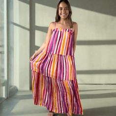 Made in USA Perfect for summer events, our Colorful Beautiful Striped Maxi Sundress will bring many compliments. Made in the USA, this dress features adjustable straps and gentle elastic gathering at the top for a comfortable fit. With a playful ruffle detail and tiered design, vibrant colors in this dress are lavender, coral, pink, orange, and white. Perfect for any summer occasion. Striped Maxi Sun Dress Adjustable Straps Gentle Elastic Gathering at Top Ruffle Detail Tiered Colors in this Dres Pink Beachwear Dress With Adjustable Straps, Multicolor Sundress With Tie Straps For Brunch, Playful Summer Dress With Tie Straps, Pink Sundress With Ruffled Straps For Beach, Pink Summer Maxi Dress With Ruffled Straps, Tiered Multicolor Sundress For Vacation, Multicolor Summer Sundress With Adjustable Straps, Summer Multicolor Dresses With Adjustable Straps, Multicolor Vacation Dresses With Ruffled Straps