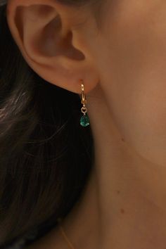 Treat yourself or a special someone to these beautiful birthstone earrings. Our signature huggie supports a vivid teardrop shape in every birthstone color, making them a perfect present. Show your friends and loved ones you care with this stylish and thoughtful accessory. Also available in Silver! Details: - Gold plated brass - Birthstone cz charm SKU: E1590G Materials+Care Gold Teardrop Hoop Earrings With Birthstone, Teardrop Hoop Earrings As May Birthstone Gift, 14k Gold Filled Birthstone Teardrop Earrings, Gold Teardrop Birthstone Earrings, Hypoallergenic Teardrop Crown Jewelry Gift, Gold Dangle Teardrop Earrings For May Birthstone, Gift Teardrop Huggie Earrings, Teardrop Earrings For May Birthstone Gift, Teardrop Earrings For Everyday - May Birthstone