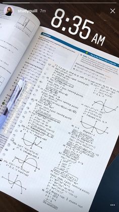 an open book with writing on it next to a calculator and pencils