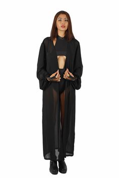 Effortlessly stylish and super versatile, our sheer black robe goes with everything in your closet. Layer it over bodysuits to keep the sun off your skin and layer it under accessories like a harness or shoulder holster bags for a unique look. FEATURES: Maxi length Made with medium weight deadstock sheer black chiffon Translucent, not completely transparent Long princess sleeves with button cuffs Removable belt Ethically handmade and 100% carbon neutral FIT NOTES:This sheer black robe is designe Gloves Dress, Shoulder Holster, Holster Bag, Princess Sleeves, Ethical Shopping, Black Chiffon, Carbon Neutral, Catsuit, Different Fabrics