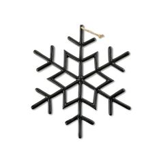 a black snowflake ornament hanging on a white wall