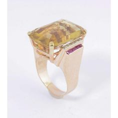 Perfect example of a 1940s cocktail ring.  It even has the synthetic rubies that were widely used during the Retro Era.  Large emerald cut citrine accented with prong set diamonds and channel set synthetic rubies.  The mounting is 18k rose gold. US size 11 - it can be sized  The ring measures .96" wide by .96" tall by .60" deep. Formal Emerald Cut Multi-stone Topaz Ring, Formal Octagon Multi-stone Rings, Formal Multi-stone Octagon Rings, Formal Multi-stone Rectangular Ring, Formal Emerald Cut Multi-stone Ruby Ring, Emerald Cut Multi-stone Ruby Ring For Formal Occasions, Retro Era, Gold Cocktail Ring, Gold Cocktail