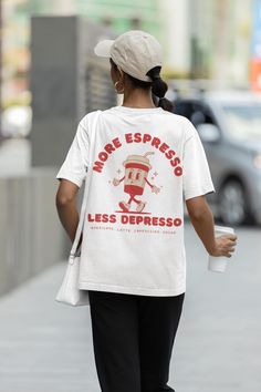 More Espresso Less Depresso Shirt, Retro Coffee Tshirt, Vintage Style Graphic Tee with a two-part design on the front and back, featuring a retro coffee cup. Order a size or two up for an oversized look.  We Offer Free UK Delivery! NOTE TO OUR CUSTOMERS We are a new business and very much appreciate your support! If you love your Tee as much as we hope you do, please leave us a review, thank you in advance- stay cosy and stay groovy! 💚 HOW TO ORDER 💚 1. Check our photos for sizing and colour o Casual Coffee Slogan T-shirt, Casual Coffee Colored Slogan T-shirt, Casual Coffee T-shirt With Slogan, Casual Coffee-colored Slogan Top, Casual Coffee Crew Neck T-shirt, Relaxed Fit Coffee Top With Funny Print, Casual Coffee T-shirt With Letter Print, Coffee T-shirt With Funny Print And Relaxed Fit, Coffee Colored T-shirt With Funny Print In Relaxed Fit