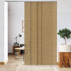 a living room with a sliding door and rugs on the floor in front of it