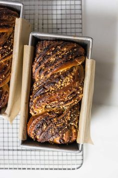 two trays filled with pastries sitting on top of a counter