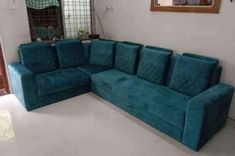 a blue couch sitting in the middle of a living room