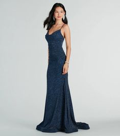 The Shay formal dress features a glitter lurex body, a sleeveless V-neckline with padded cups, adjustable spaghetti straps, and a ruching. Her slim-fit waist leads to a mermaid silhouette accented with a wide-banded hem and train. She is composed of a lined glitter lurex fabric that offers a form-hugging fit. Dark Blue Sparkly Dress, Navy Blue Sparkly Dress, Sparkly Dress Long, Dark Blue Sequin Dress, Navy Blue Sequin Dress, Lurex Fabric, Glitter Dress, Mermaid Silhouette, Maxi Dress Formal