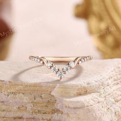 a diamond ring sitting on top of a rock