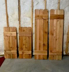 several pieces of wood sitting next to each other on the floor in front of a wall