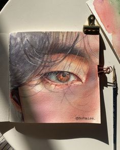 a drawing of an eye on top of a piece of paper