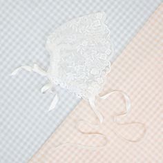 Handmade in the USA This sheer lace bonnet is the perfect accent for any special event or day! Made with the same floral netting lace as the Ella romper dress, using the scalloped edge of the lace to make a lovely frame for baby's face! Silk ribbon ties can be used to secure the bonnet on baby, and a tie on the back can be used to adjust the fit, to make it just right for her! Light ivory floral embroidered netting lace Ivory Venice lace Ivory silk satin ribbon Fitted Scalloped Lace Tulle, Scalloped Lace Tulle Fabric, Elegant Tulle Lace With Lace Trim, Fitted Scalloped Lace For Ceremony, Fitted Delicate Cream Lace, Delicate Fitted Cream Lace, Cream Fitted Delicate Lace, Elegant Lace Bonnet With Lace Trim, Fitted White Bonnet With Lace Trim