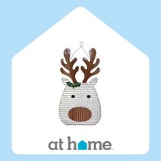 an ornament with a reindeer's head and antlers on it that says at home