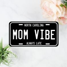 a black and white license plate that says north carolina mom vibe always late on it