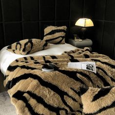 a zebra print bed spread on top of a white bed