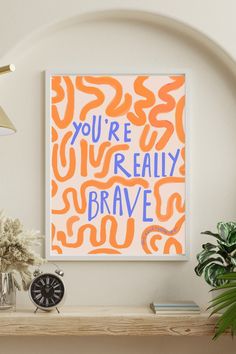 an orange and white art print with the words you're really brave