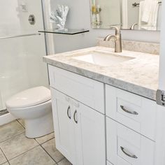 a bathroom with a sink, toilet and shower