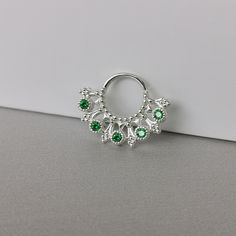 16 gauge tribal emerald Septum Ring ,Silver Daith piercing  -Material:  925 Sterling Silver -AAA Emerald CZ size: 2 x 2 mm -Hoop size: 8 x 8 mm inner  -Gauge : 16 G  ~This listing is for one sterling silver hoop piercing. **TWIST HOOP TO PUT IN**  All items will be shipped with tracking number. Please note that delivery ranges between 1-4 weeks, depending on the country of destination. Thank you for visiting Gemsfieldshop Sterling Silver Hoop Earrings For May Birthstone, Silver Internally Threaded Hoop Body Jewelry, Pierced Sterling Silver Belly Rings, Silver Small Hoop Belly Rings As Gift, Silver Sterling Belly Rings, Silver Internally Threaded Hoop Septum Ring, Silver Hoop Belly Rings, Internally Threaded Silver Hoop Nose Rings, Silver Internally Threaded Small Hoop Belly Ring