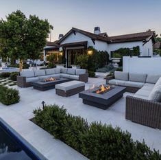 an outdoor living area with couches and fire pit