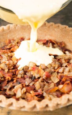 a pie with toppings being poured into it