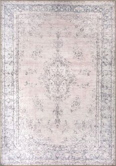 an antique rug with blue and white accents on the border, in neutral tones that appear to be hand - knotted