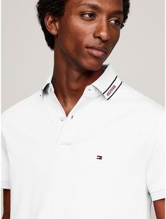 Tommy Hilfiger men's polo. Introducing our cotton interlock polo, known for its smooth handfeel and durability, cut in an easy fit and finished with our monotype logo stripe at the collar.  Material: 100% Cotton (rgc). Classic Collared Polo Shirt With Signature Stripes, Classic Polo Shirt With Signature Stripes, Classic Polo Shirt With Striped Collar For Golf, White Collared Polo Shirt With Signature Stripes, Mens Apparel, Tommy Hilfiger Man, Men's Polo, Mens Polo, Tommy Hilfiger