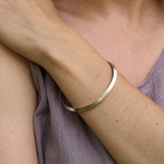 A smooth bangle with a triangular shape. These are great for layering or worn alone. Polished Sterling Silver 5mm width 2.5" inner diameter Handmade in Colorado By Nikki Nation "Modern, yet organic forms, mixed with forging and hammering techniques are what inspire my jewelry designs. All pieces are handmade using traditional methods of metalsmithing such as fabrication, forming, texturing, and stone setting. We believe in sustainability and only use recycled metals, conflict free or recycled ge Modern Hammered Bangle For Everyday Wear, Modern Hammered Bangle For Everyday, Modern Hammered Bracelets For Everyday, Minimalist Hammered Cuff Bangle Bracelet, Minimalist Hammered Bangle For Everyday, Minimalist Hammered Cuff Bracelet, Minimalist Everyday Hammered Bangle, Everyday Minimalist Hammered Bangle, Minimalist Hammered Bracelet Bangle