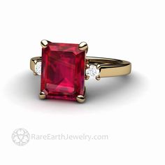 "A beautiful three stone Ruby engagement ring with a gorgeous 4.25ct emerald cut lab grown Ruby. There are two natural diamonds, one on each side of the center stone, .14 carats total weight. Simply stunning. Ruby is the birthstone forJuly. Available in 14K or 18K White, Yellow or Rose Gold and Platinum. Made to order. Please allow three to four weeks for delivery. Inquire for the matching wedding band. Lab grown Rubies are physically, chemically and optically identical to natural sapphires. The Formal Three Stone Emerald Cut Ruby Ring, Formal Emerald-cut Ruby Ring With Three Stones, Formal Emerald Cut Three-stone Ruby Ring, Gift Emerald Ring With Three Stones In Radiant Cut, Three Stone Ruby Engagement Ring, Irish Promise Rings, Engagement Ring Emerald Cut, Engagement Ring Emerald, Simple Wedding Bands