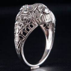 Vintage 1930s Platinum Old Euro Diamond Filigree Engagement Ring 1.50ctw 5.45gMetal Information: .900 PlatinumTotal Weight: 5.45gBand Width: 1.6mmSize: 5.75Circa: 1930'sStone InformationMain StoneGem Type: DiamondShape: Old European (5.2mm)Color: HClarity/Quality: SI1Carat Weight: .50ctNumber of Stones: 2Accent StonesGem Type: DiamondShape: Old European (3.95mm)Color: HClarity/Quality: SI1Carat Weight: .25ctNumber of Stones: 2Total estimated ctw (carat total weight): 1.50ctwEstimated Retail Pric Antique Platinum Three Stone Rings, Antique Three Stone Platinum Rings, Antique Platinum Three-stone Jewelry, Vintage Platinum Three-stone Jewelry, Vintage Three-stone Platinum Jewelry, Vintage Three Stone Platinum Jewelry, Heirloom Three-stone Platinum Jewelry, Estate Platinum Rings With Prong Setting, Estate Platinum Rings With Brilliant Cut