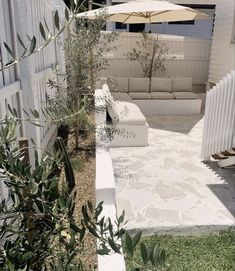 an outdoor seating area with umbrellas in the background