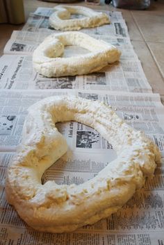 two pretzels sitting on top of a newspaper next to each other with holes in them