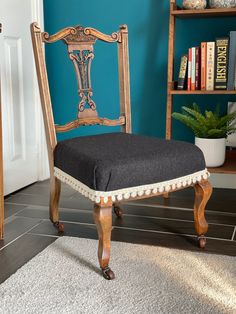 a chair sitting in front of a bookshelf with blue walls and white carpet