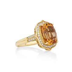 Indulge in the mesmerizing allure of this 5.04 Cts Citrine and White Diamond Ring. Crafted in 14K yellow gold, this exquisite piece showcases a stunning citrine gemstone surrounded by a halo of dazzling white diamonds. With its timeless design and elegant sparkle, this ring is a true statement of beauty. Luxury Citrine Rings With Diamond Accents, Luxury Citrine Diamond Ring With Halo Setting, Luxury White Gold Citrine Diamond Ring, Luxury Yellow Citrine Gemstones, Yellow Gold Citrine Gemstone With Center Stone, Gold Cushion Cut Topaz Ring For Formal Occasions, Formal Gold Cushion Cut Topaz Ring, Citrine Gemstones With Center Stone, Classic Yellow Gold Topaz Ring With Gemstone Accents