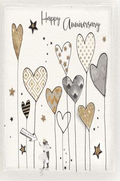 an anniversary card with hearts and stars on the front, in gold foil lettering that says happy anniversary