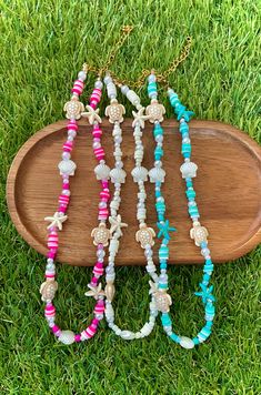 This beautiful coastal-themed beaded necklace is a stunning addition to your summer accessories. This necklace is made of fun tropical beads. Beads vary from being made out of plastic, acrylic, polymer clay, glass, and resin. The string is made out of a non-stretch elastic cord. This necklace is about 15 inches in length. This length can be increased by anywhere from 0.1 inches to (at max) 2.75 inches. The extender chain is 2.75 inches in length. This necklace can be closed by its gold-plated lo Beach Jewelry With Beaded Chain Strand, Summer Ocean-inspired Beaded Necklaces, Ocean-inspired Beaded Necklace For Summer, Beach Season Jewelry With Beaded Chain, Turquoise Beaded Necklace With Letter Beads For Beach, Bohemian Heart Beads Bracelet For Beach, Trendy Summer Shell Necklace For Beach, Turquoise Beaded Necklaces With Letter Beads For Beach, Trendy Shell Necklace For Summer Vacation