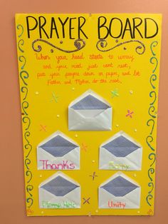 a bulletin board with some writing on it that says prayer board and three envelopes