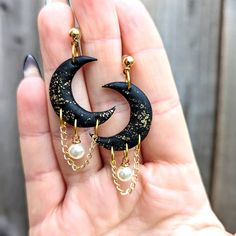 Gothic celestial crescent moon dangles with pearl and chain embellishment for the dark soul in you. The ideal witchy gift for yourself or another Goddess in your life. The main jewellery body is handcrafted from polymer clay, with gold-plated ball posts and chain. Lightweight and durable. If you have any questions, please do reach out and I will answer you ASAP. Mystic Clay Designs operates a no return/cancellation policy, due to the made to order nature of these products. However, if you do hav Witchy Aesthetic Jewelry, Polymer Clay Witchy Earrings, Polymer Clay Jewelry With Crystals, Air Dry Clay With Crystals, Witch Aesthetic Jewelry, Polymer Clay Gothic Jewelry, Celestial Polymer Clay Earrings, Homemade Clay Jewelry, Kitchy Jewelry