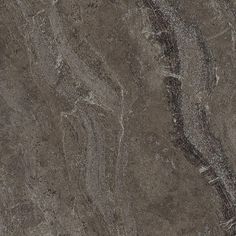 a close up view of the surface of a marbled floor with dark brown and gray colors