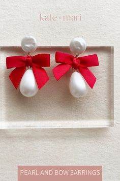 Sweet and simple, our pearl and bow earrings feature a mother of peal drop, a freshwater coin pearl stud measuring 12mm and a mini bow measuring 1 1/4 inches wide. Total length is approx 2 inches long and 1.25 inches wide. Part of our demi fine collection. Available in ivory, red, black and navy. Gift Pearl Earrings With Pearl Charm, White Pearl Jewelry With Ribbon, White Pearl Jewelry With Ribbon Detail, White Jewelry With Bow For Gifts, Elegant Jewelry With Red Bow For Gifting, Pearl Jewelry With Bow Detail, White Pearl Earrings With Bow For Wedding, Formal Pearl Earrings With Bow Detail, Formal Pearl Earrings With Bow