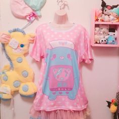 "Is a nurse bear taking care of her patient. The word in japanese means \"PAIN\" This new all over print t-shirt features a relaxed fit for Cuties. Made of 100% mesh cloth, this t-shirt is durable, breathable and soft. * 7.05 Oz. 100% polyester. * Double-needle hemmed sleeves and bottom. * Machine wash cold. The print on garment body is unable to fade. Color may appear different in the photo. Thank you'ω ♥ ☆ ★ ♪ Model by: katiebabydoll" Casual Pink T-shirt For Pajama Party, Pink Kawaii Sleepwear With Cartoon Print, Casual Graphic Print T-shirt For Pajama Party, Printed Short Sleeve Tops For Bedtime, Casual Cartoon Print Sleep Top, Casual Sleep Tops With Cartoon Print, Playful Pink Short Sleeve T-shirt, Casual Cartoon Print Tops For Pajama Party, Casual Hello Kitty Print Tops For Sleepover