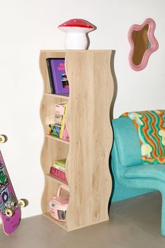 a skateboard is sitting next to a book shelf