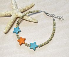 Cute and colorful beachy boho summer anklet!  This was created using "yellow" Japanese Picasso seed beads, tiny turquoise seed beads, and Howlite gemstone star beads in turquoise blue and orange.  Anklet closes with a lobster clasp, and is adjustable with a 1" extender chain. Anklet measures 9-1/4" to 10-1/4" with the extender chain. Thank you for shopping with The Lucie Collection! Bohemian Beaded Friendship Bracelets For Beach Season, Bohemian Turquoise Starfish Beaded Bracelets, Turquoise Beaded Starfish Bracelets For Summer, Turquoise Starfish Beaded Bracelets For Summer, Bohemian Beaded Bracelet With Starfish For Beach Season, Bohemian Starfish Beaded Bracelet For Beach Season, Bohemian Beaded Bracelet With Starfish Charm For Vacation, Summer Turquoise Beaded Bracelets With Starfish Shape, Bohemian Adjustable Beaded Bracelets With Starfish Shape