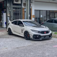 a white car parked in front of a building