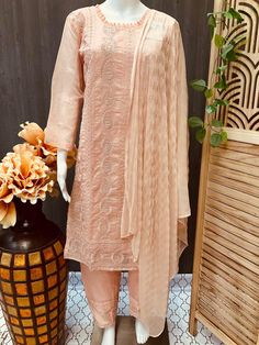 Embrace elegance with Anandi Fashions' exquisite 3 piece Organza Chudidhar set/Kurti set in peach color, crafted to perfection for size 40/US S. This stunning ensemble includes a finely detailed kurti, comfortable chudidhar, and an ethereal dupatta, all made from premium organza fabric that radiates sophistication. Ideal for any festive occasion or cultural gathering, the delicate peach color adds a touch of grace and charm to your wardrobe. At Anandi Fashions, we pride ourselves on delivering high-quality Indian ethnic wear that celebrates tradition and craftsmanship. Enhance your ethnic collection with this versatile and timeless piece, reflecting our commitment to style and cultural heritage. Designer Wear Beige Sets With Dabka Detailing, Beige Georgette Sets For Designer Wear, Beige Georgette Designer Wear Sets, Designer Beige Sets With Dabka Details, Bollywood Peach Traditional Drape Sets, Unstitched Peach Sets In Traditional Drape, Elegant Semi-stitched Pink Churidar, Elegant Peach Sharara With Traditional Drape, Fitted Beige Georgette Set