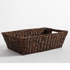 a brown wicker basket on a white background